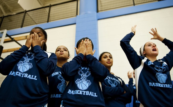 The Skyline High School girls varsity basketball team reacts to the conclusion of the junior varsity game on Friday. Daniel Brenner I AnnArbor.com